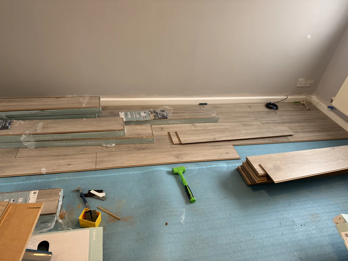 home-renovation-laminate-flooring-planks-laid-swansea-daffodil-decor Home renovation in Swansea with laminate flooring being laid during redecoration project by Daffodil Decor