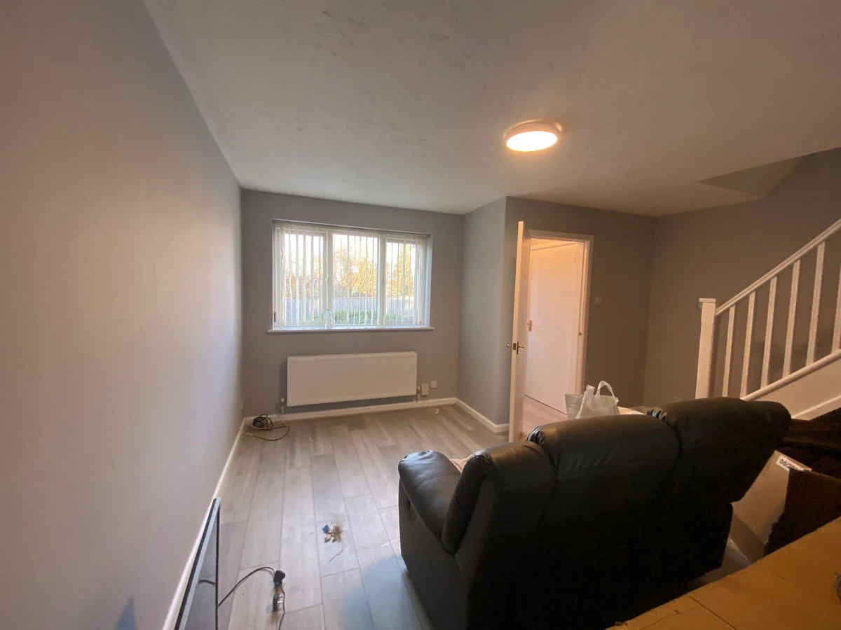 living-room-painting-grey-walls-laminate-floor-swansea-daffodil-decor Living room painted grey with laminate flooring ready for furniture, Swansea
