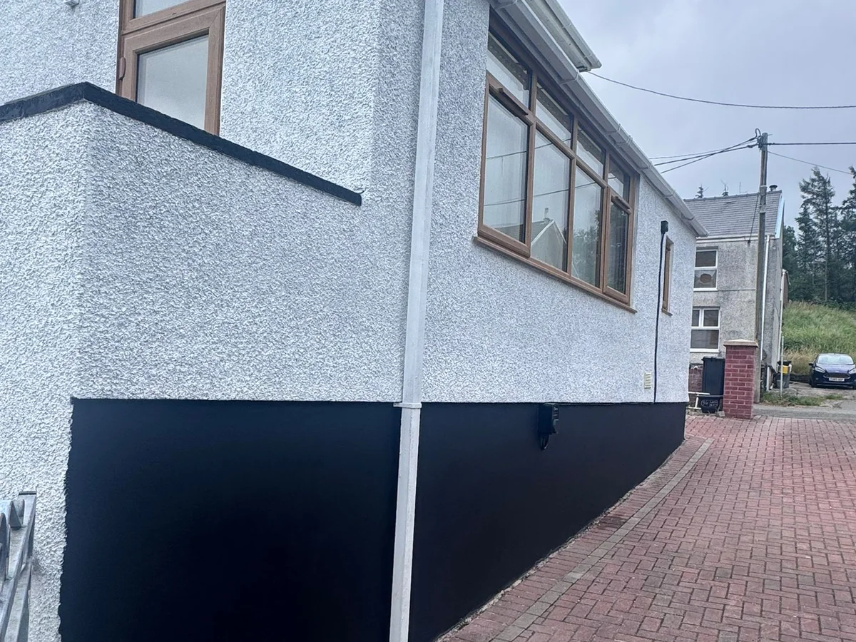 Painted pebbledash with black plinth by decorators covering Landore, Swansea