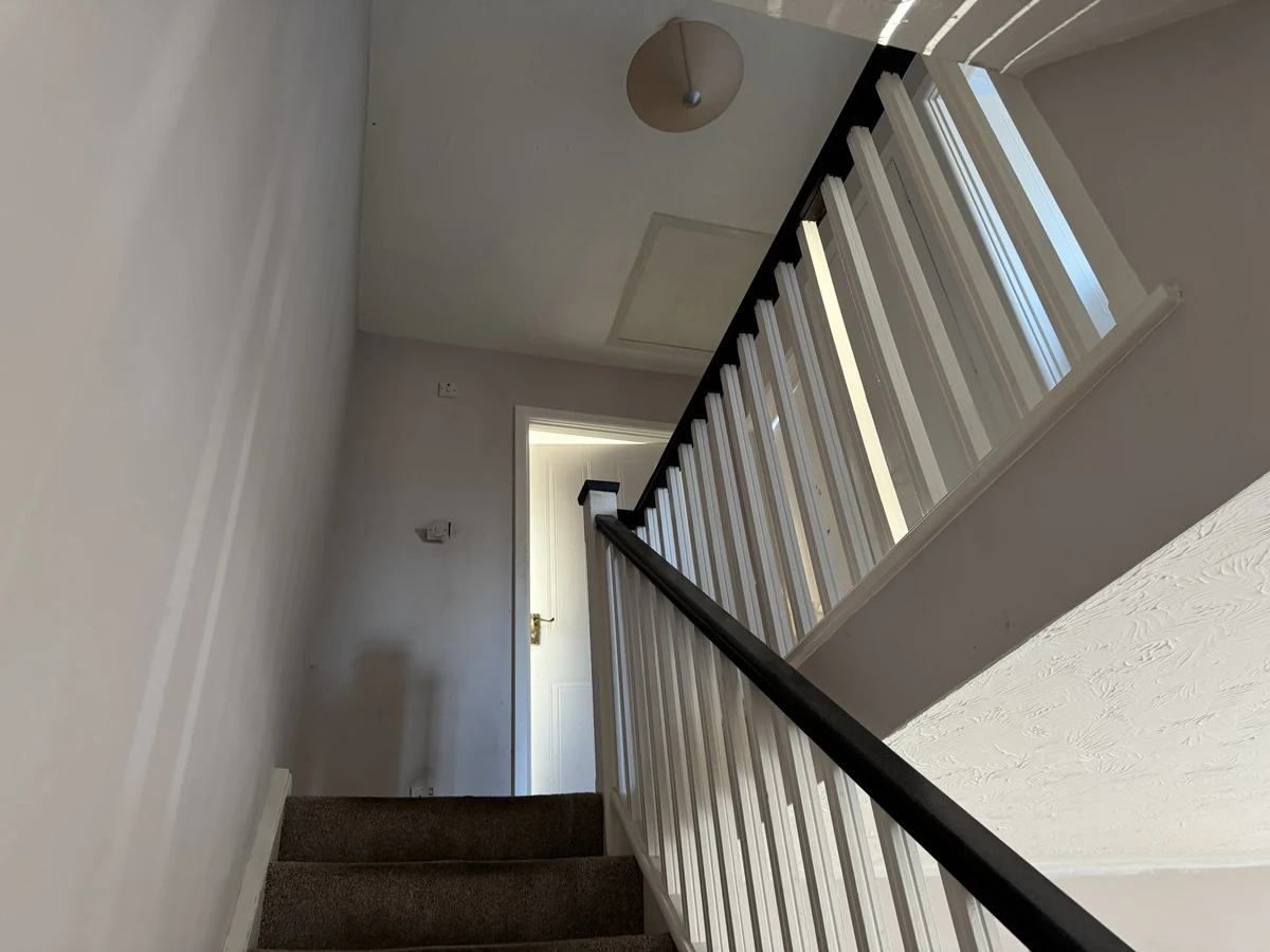 staircase-painting-mid-flight-white-walls-ceiling-swansea-daffodil-decor Staircase mid-flight with freshly painted white walls and ceiling after plastering, Swansea